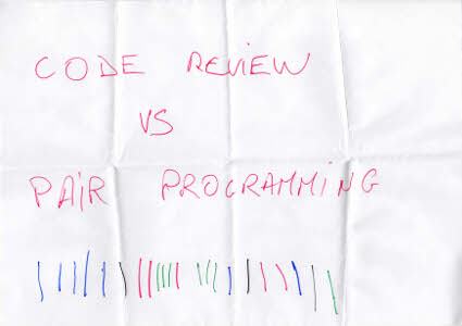 A paper with "Code Review vs Pair Programming" and sticks for each votes